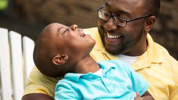 Young father talking and laughing with preschool son