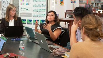 multicultural group of teachers engaged in school-based discussion about teaching