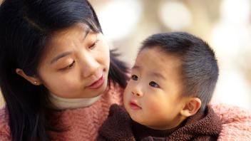 Asian mom talking with her toddler