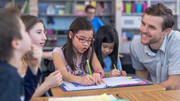 Elementary teacher working on reading lesson with small group