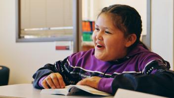 ELL student reading a text in class