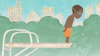 Young African American boy on diving board looking down into the water