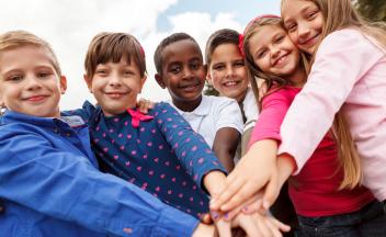 Diverse group of elementary kids holding hands