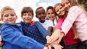 Diverse group of elementary kids holding hands