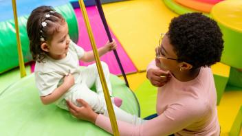 preschool teacher using sign language with toddler