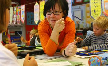 elementary teacher talking with students during lesson