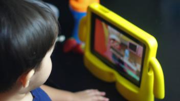 Young toddler looking at tablet screen